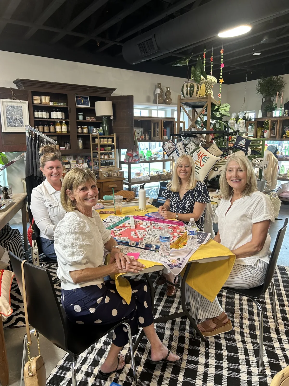 A group of players gathered around a mahjong table at Linden Tree Gifts